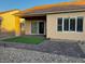 Home with a patio, small grass area, desert landscaping, and a sliding door at 2704 Willow Wren Dr, North Las Vegas, NV 89084