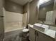 Bathroom with white cabinets, marble countertop, and a square sink next to a bathtub/shower combo at 2704 Willow Wren Dr, North Las Vegas, NV 89084