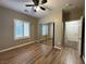 Bedroom featuring a window with plantation shutters and mirrored closet doors at 2704 Willow Wren Dr, North Las Vegas, NV 89084