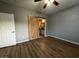 Spacious bedroom features wood floors, ceiling fan, and en suite bathroom with sliding barn door at 2704 Willow Wren Dr, North Las Vegas, NV 89084