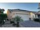 Charming single-story home featuring a two-car garage, solar panels, and desert landscaping at 2704 Willow Wren Dr, North Las Vegas, NV 89084