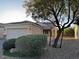 Single-story home with a two-car garage, solar panels, complemented by desert landscaping at 2704 Willow Wren Dr, North Las Vegas, NV 89084