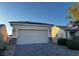 Two-car garage with solar panels and desert landscaping at 2704 Willow Wren Dr, North Las Vegas, NV 89084