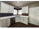 Modern kitchen with white cabinets and stainless steel appliances at 2704 Willow Wren Dr, North Las Vegas, NV 89084