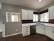 Well-lit kitchen with stainless steel appliances and white cabinets at 2704 Willow Wren Dr, North Las Vegas, NV 89084