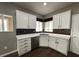 A corner view of the kitchen featuring white cabinets and a stainless steel dishwasher at 2704 Willow Wren Dr, North Las Vegas, NV 89084