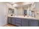 Clean bathroom featuring double sinks, a large mirror, and a neutral color palette at 2789 Trotwood Ln, Las Vegas, NV 89108