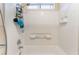 Shower and bathtub combo with white tile and a shower caddy for convenience at 2789 Trotwood Ln, Las Vegas, NV 89108