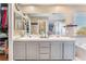 Bathroom featuring double sinks, a large mirror, walk-in closet, and bath tub at 2789 Trotwood Ln, Las Vegas, NV 89108