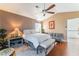 This bedroom features a ceiling fan, queen bed, seating, and great lighting at 2789 Trotwood Ln, Las Vegas, NV 89108
