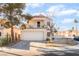 Two-story home featuring a balcony, two car garage, xeriscaped front yard, and a red tile roof at 2789 Trotwood Ln, Las Vegas, NV 89108