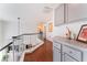 Bright hallway with wood floors, overhead lighting, and gray cabinets at 2789 Trotwood Ln, Las Vegas, NV 89108