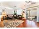 Comfortable living room with a large sectional couch, patterned rug, and sliding glass door at 2789 Trotwood Ln, Las Vegas, NV 89108