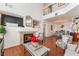 Bright living room with fireplace, hard wood flooring, stairway and dining area at 2789 Trotwood Ln, Las Vegas, NV 89108