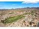 Scenic aerial view showcasing homes near golf course and desert landscape, offering a unique blend of recreation and natural beauty at 3029 Brownbirds Nest Dr, Henderson, NV 89052