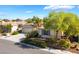 Aerial view of a single-story home with mature trees, desert landscaping, and a paved driveway at 3029 Brownbirds Nest Dr, Henderson, NV 89052