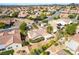 Aerial view of a charming home with mature trees, desert landscaping, a covered patio, and a beautiful community at 3029 Brownbirds Nest Dr, Henderson, NV 89052