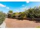 Large gravel backyard with a retaining wall, creating a tiered landscape and visual interest at 3029 Brownbirds Nest Dr, Henderson, NV 89052