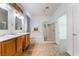 Bathroom with double vanity, walk in shower, and neutral tile flooring at 3029 Brownbirds Nest Dr, Henderson, NV 89052