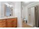 Bathroom featuring a vanity with a wooden cabinet, a mirror, and a shower with a beige curtain at 3029 Brownbirds Nest Dr, Henderson, NV 89052