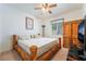 Bedroom with unique wood bed frame, ceiling fan, and window at 3029 Brownbirds Nest Dr, Henderson, NV 89052