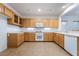 Bright kitchen with wooden cabinetry, white countertops and tile flooring at 3029 Brownbirds Nest Dr, Henderson, NV 89052