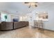 Cozy living room with tile flooring, ceiling fan, and seamless access to the kitchen and dining areas at 3029 Brownbirds Nest Dr, Henderson, NV 89052