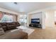 Comfortable living room with tile floors, large sofa, and a view into the dining area at 3029 Brownbirds Nest Dr, Henderson, NV 89052