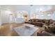 Bright living room with tile floors, large sofa, and a welcoming open floor plan at 3029 Brownbirds Nest Dr, Henderson, NV 89052