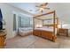 Spacious main bedroom with four-poster bed and sitting area at 3029 Brownbirds Nest Dr, Henderson, NV 89052