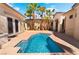 Inviting backyard pool with clear blue water, surrounded by a patio and lush palm trees at 3029 Brownbirds Nest Dr, Henderson, NV 89052