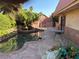 Lush backyard featuring a unique in-ground pool, rock accents, mature landscaping, and patio space at 3167 El Cedro Cir, Las Vegas, NV 89121