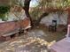 Private backyard with flagstone patio, lush trees providing shade, built-in benches, and a serene atmosphere at 3167 El Cedro Cir, Las Vegas, NV 89121