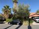 Front of a house with mature landscaping, a driveway, and parked cars, showcasing curb appeal at 3167 El Cedro Cir, Las Vegas, NV 89121