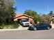 Charming single-story home with a tile roof and two cars parked in the driveway on a sunny day at 3167 El Cedro Cir, Las Vegas, NV 89121