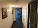 Hallway with stone floors and neutral walls, leading to other rooms in the home with ambient lighting at 3167 El Cedro Cir, Las Vegas, NV 89121
