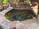 Hot tub surrounded by rock and flowers, great for relaxation at 3167 El Cedro Cir, Las Vegas, NV 89121