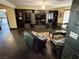 Spacious living room featuring a unique stone floor, custom built-ins, and comfortable seating arrangement at 3167 El Cedro Cir, Las Vegas, NV 89121