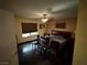 Main bedroom with dark wood floors, ceiling fan and a large bed with an upholstered headboard at 3167 El Cedro Cir, Las Vegas, NV 89121
