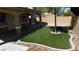 Artificial grass surrounded by a concrete border and rocks at 3606 Gold Sluice Ave, North Las Vegas, NV 89032