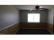 This bedroom features a ceiling fan, carpet flooring, and a large window at 3606 Gold Sluice Ave, North Las Vegas, NV 89032