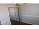 Bedroom features a mirrored closet door, ceiling fan and carpeting at 3606 Gold Sluice Ave, North Las Vegas, NV 89032