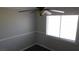 Bright bedroom features a large window and neutral color scheme at 3606 Gold Sluice Ave, North Las Vegas, NV 89032