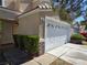 Charming home featuring a two-car garage, well-kept landscaping, and a secure front door at 3606 Gold Sluice Ave, North Las Vegas, NV 89032