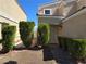 Home featuring a well-maintained yard with decorative bushes leading to the front door at 3606 Gold Sluice Ave, North Las Vegas, NV 89032