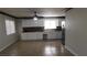 Open kitchen layout with white cabinets, stainless steel appliances, and tile flooring at 3606 Gold Sluice Ave, North Las Vegas, NV 89032