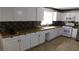 Updated kitchen featuring white cabinetry, granite countertops, and ample natural light at 3606 Gold Sluice Ave, North Las Vegas, NV 89032