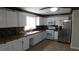 Updated kitchen with white cabinetry, granite countertops, and stainless steel appliances at 3606 Gold Sluice Ave, North Las Vegas, NV 89032