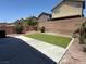 Backyard featuring a concrete patio, artificial turf area, and desert landscaping at 3736 Gallowtree Ave, North Las Vegas, NV 89081