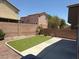 Private backyard with synthetic lawn area and mature landscaping at 3736 Gallowtree Ave, North Las Vegas, NV 89081